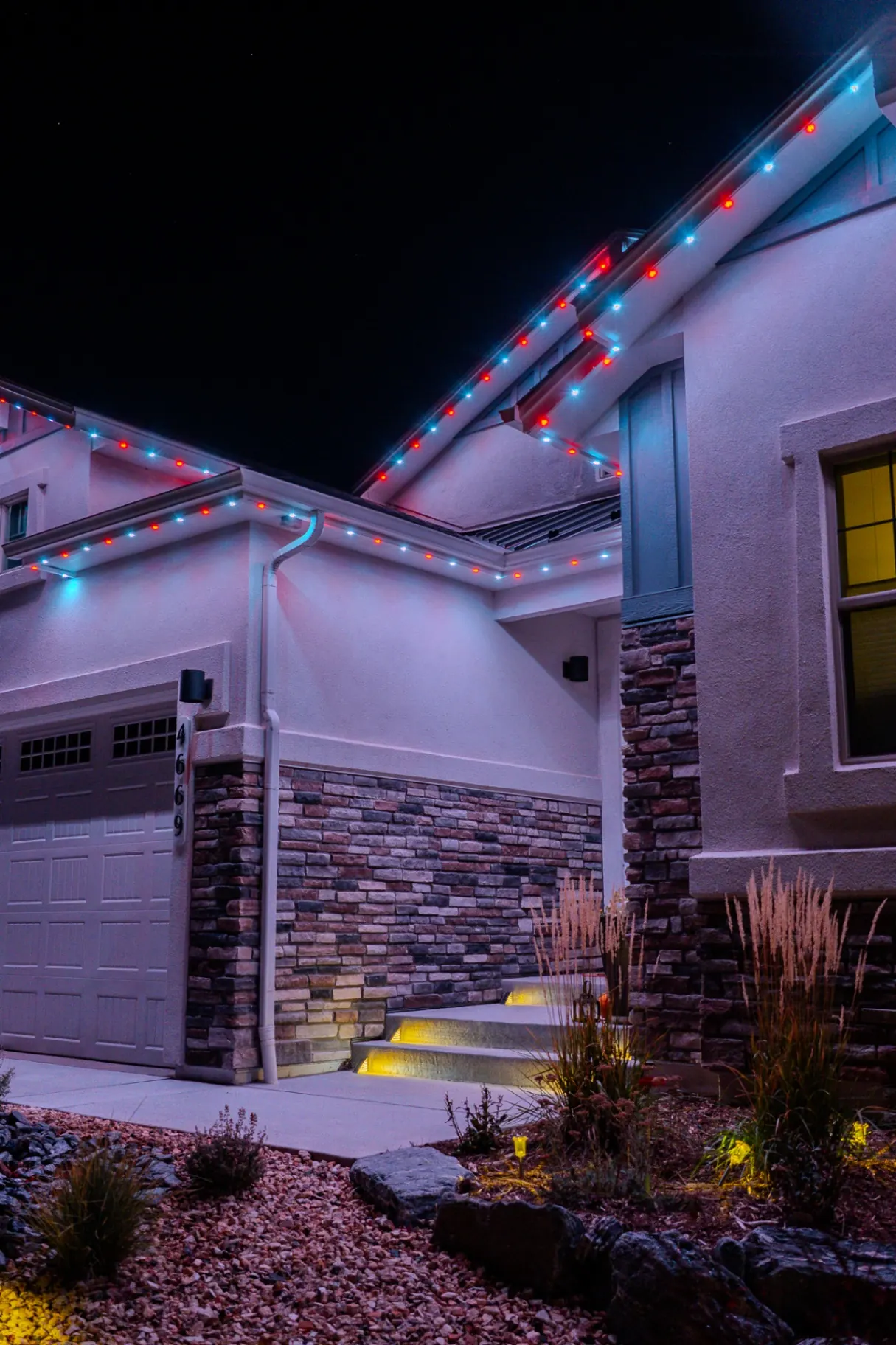 Red, white, and blue patriotic lighting on a modern home