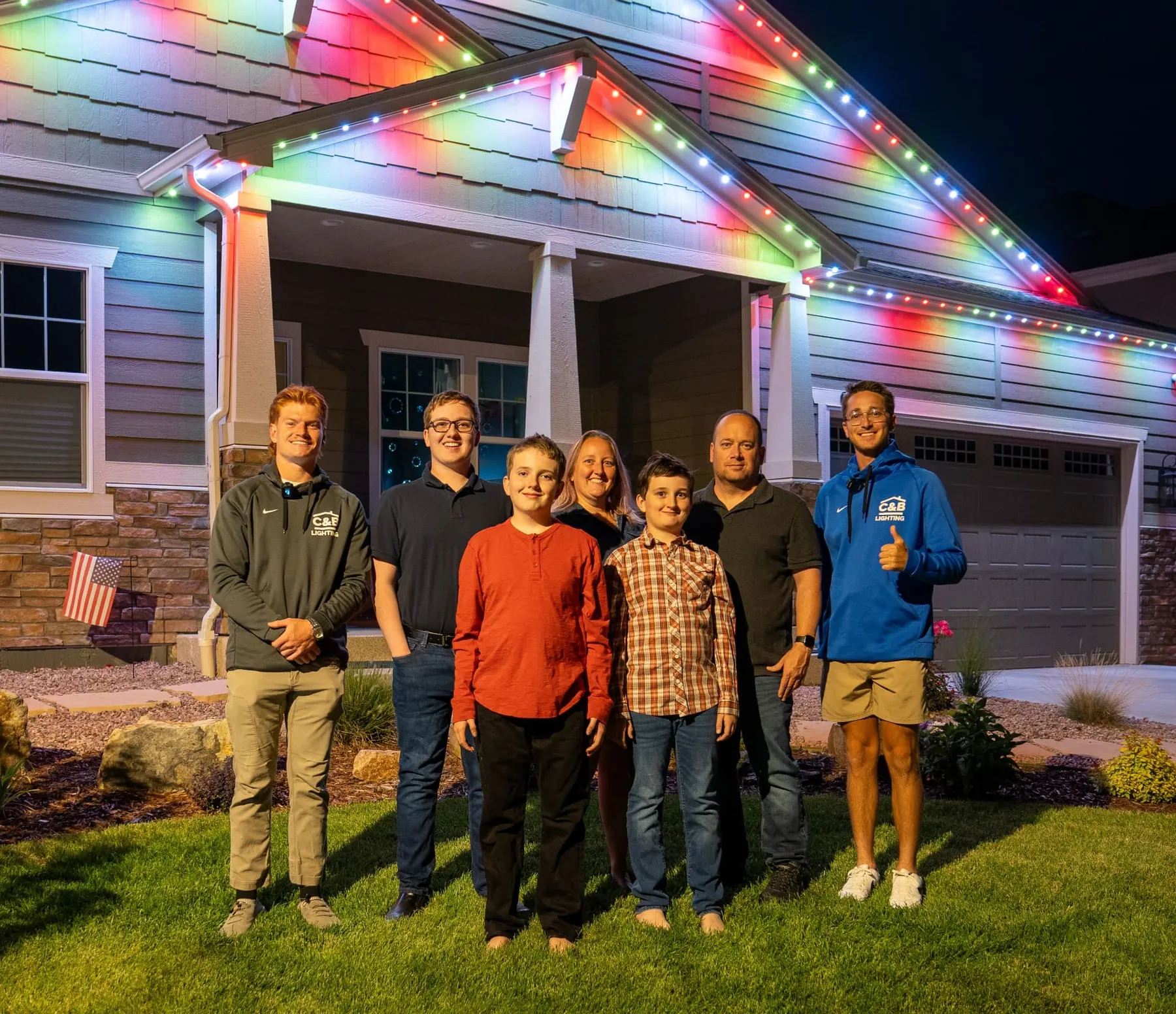 Mountain House Lighting customers in front of their beautifully lit home