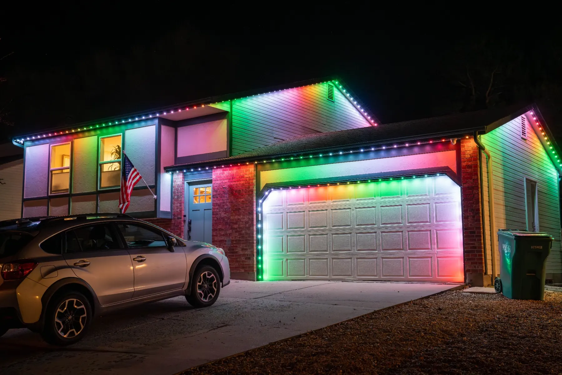 Vivid multicolor lighting on a home with American flag