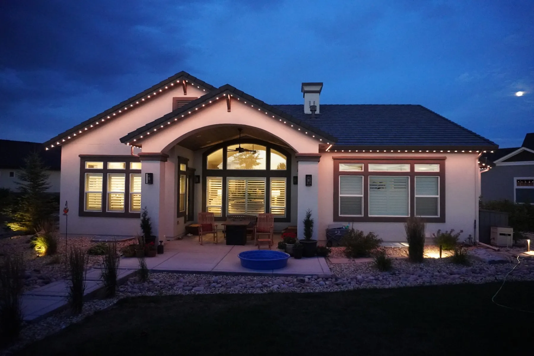 Warm white permanent lighting across a modern single-story home