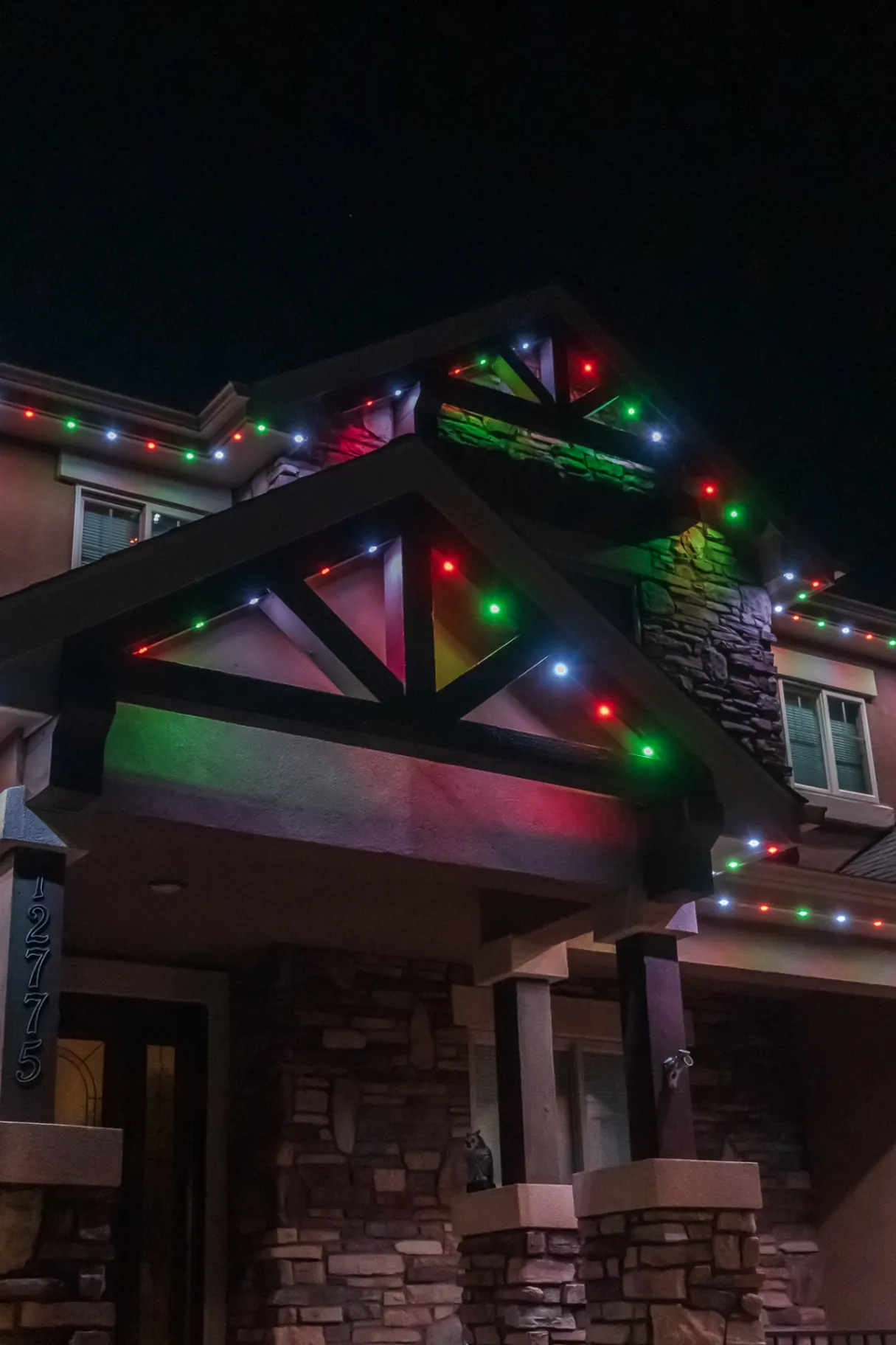 Red, green, and white classic Christmas lighting on timber accents