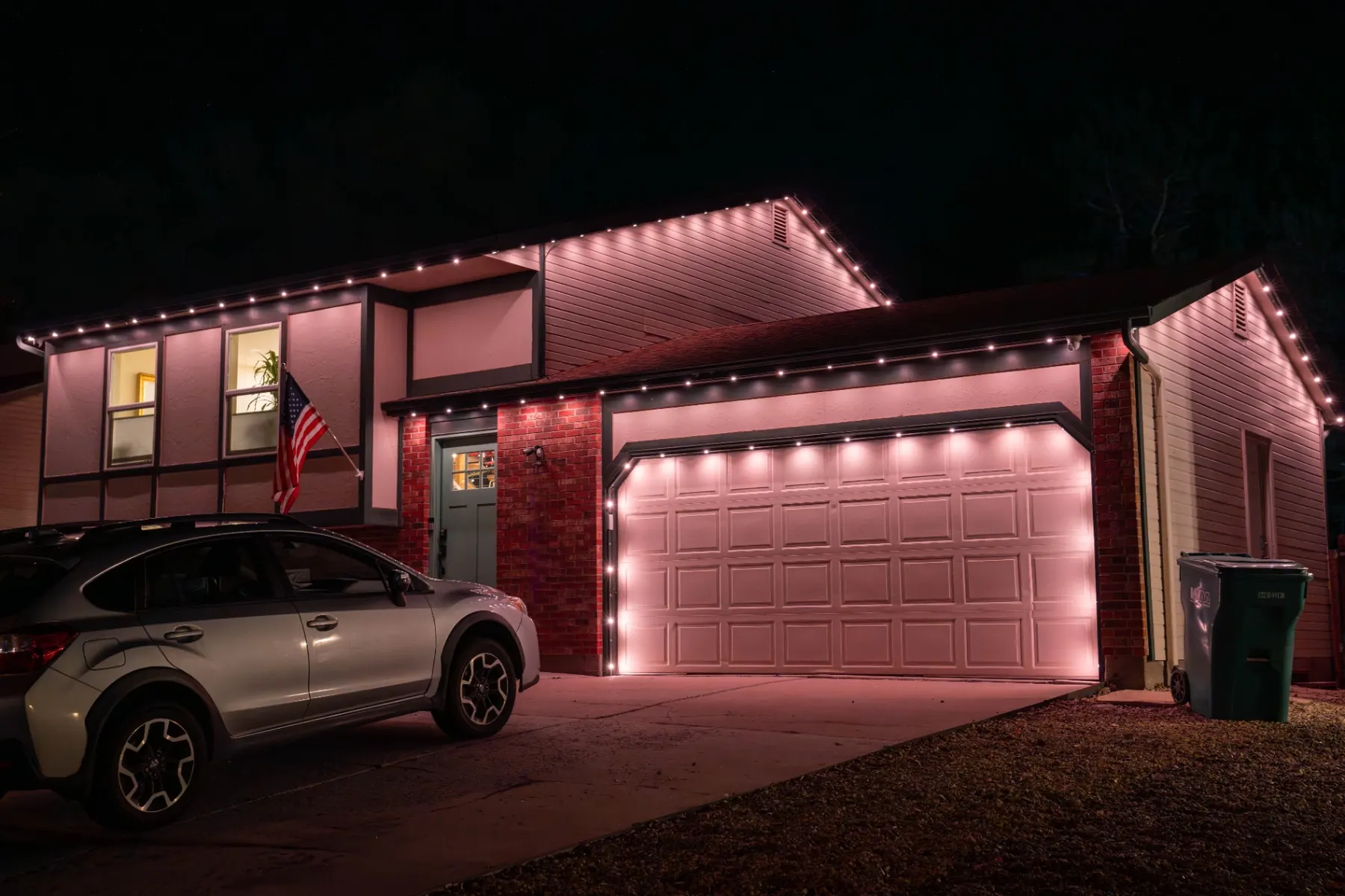 Soft pink-white permanent lighting on a garage and roofline